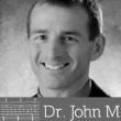 Dr. John M